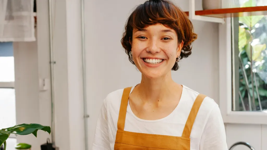 woman wearing an apron smiling