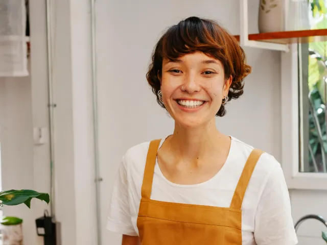 woman wearing an apron smiling