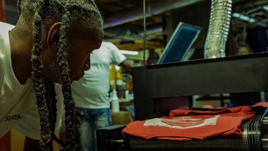 Blake, owner of Guapaholics, screenprinting