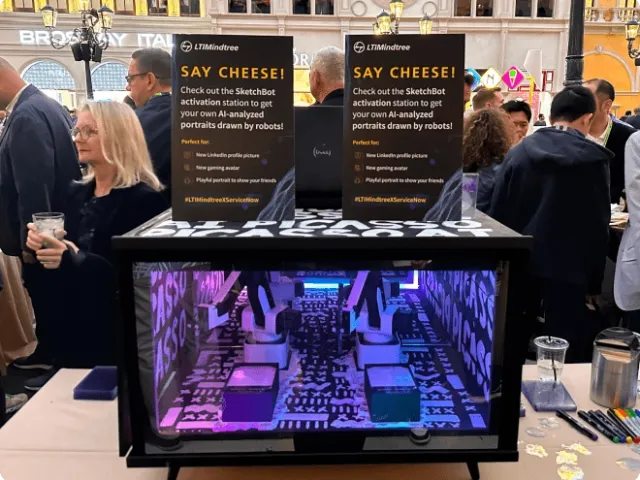 a booth at an event advertising a drawing machine