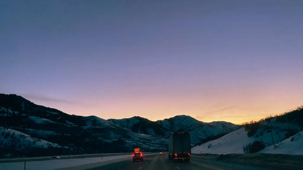 Cars driving during sunset on a winter highway