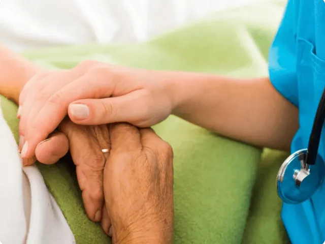 hand of a medical profession on two hands of an older person