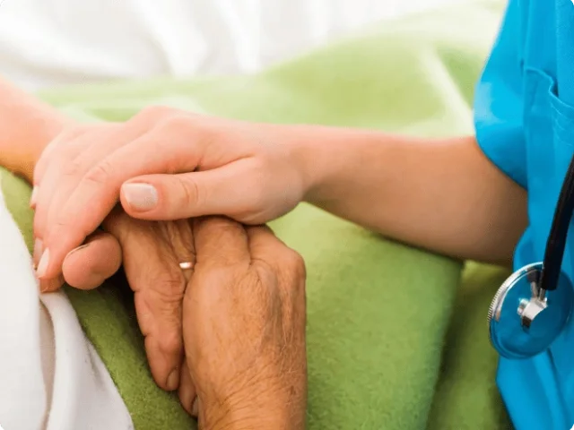 hand of a medical profession on two hands of an older person