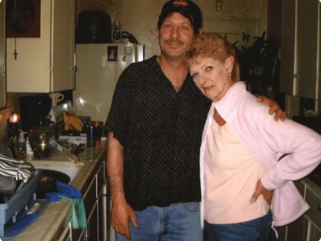 two people standing in a kitchen