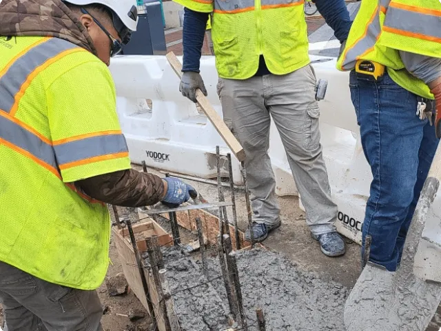 three men at a construction site
