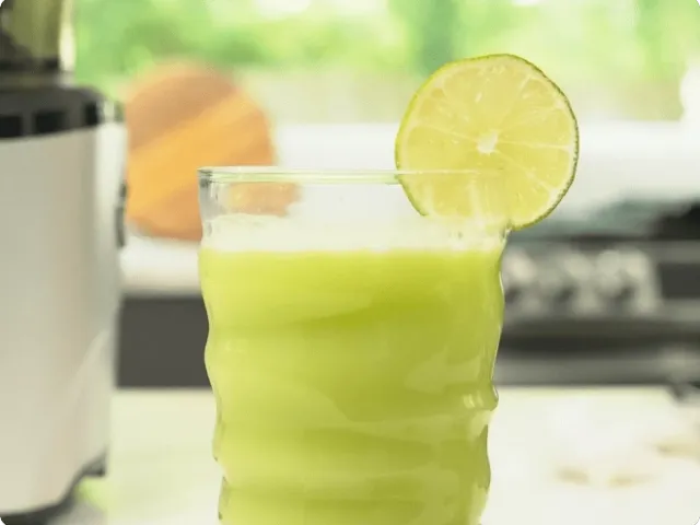 a cup filled with green juice