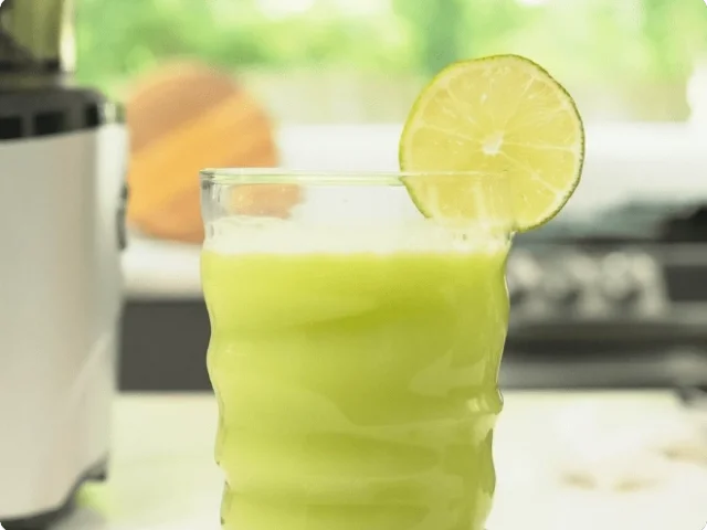 a cup filled with green juice