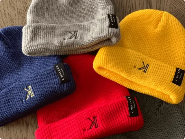 four beanies of various colors