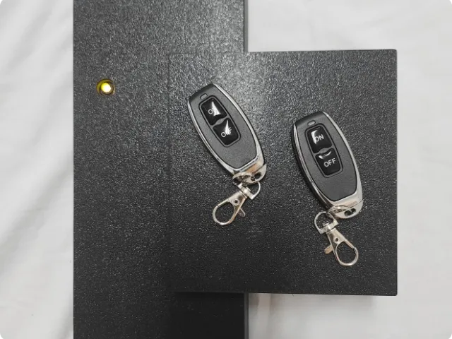 two car keys on black hardware
