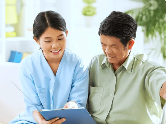 a woman and an older man looking at papers together