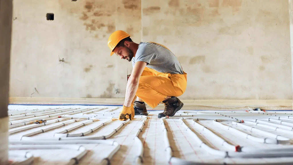 A man prepares a floor for new flooring