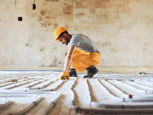 A man prepares a floor for new flooring