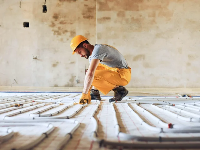 A man prepares a floor for new flooring