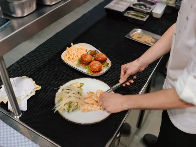 A chef plates a meal
