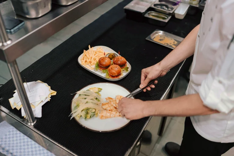 A chef plates a meal