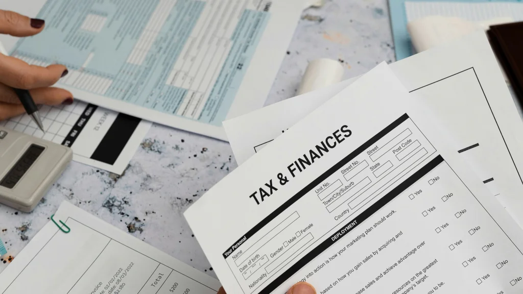 Hand holding tax and financial paperwork
