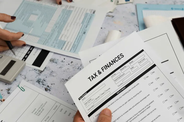 Hand holding tax and financial paperwork