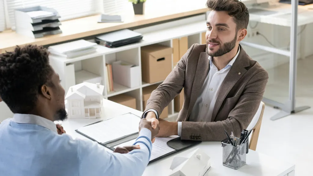 Man shakes hand after closing on his SBA loan