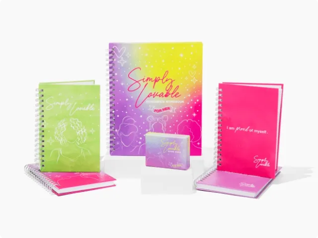 an assortment of rainbow and sparkled notebooks