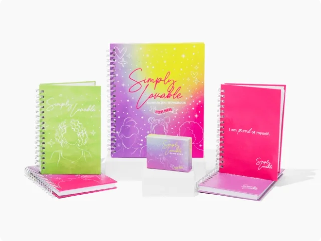 an assortment of rainbow and sparkled notebooks