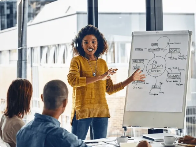 photo of a woman presenting in a conference room