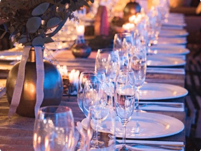 setup of a dinner party, nighttime with lights
