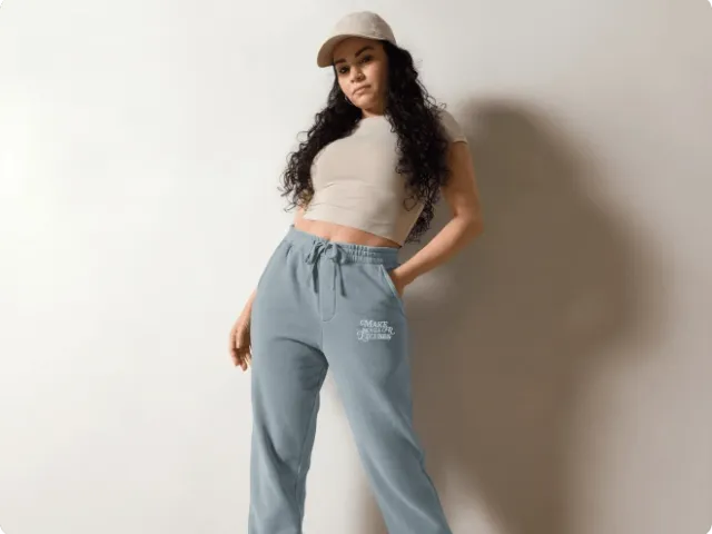 model posing wearing a hat, crop top shirt, and joggers