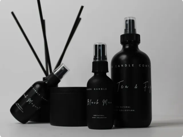 black spray bottles and reed diffuser