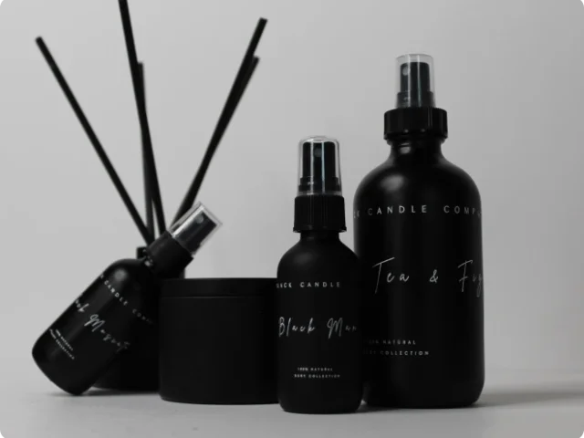 black spray bottles and reed diffuser