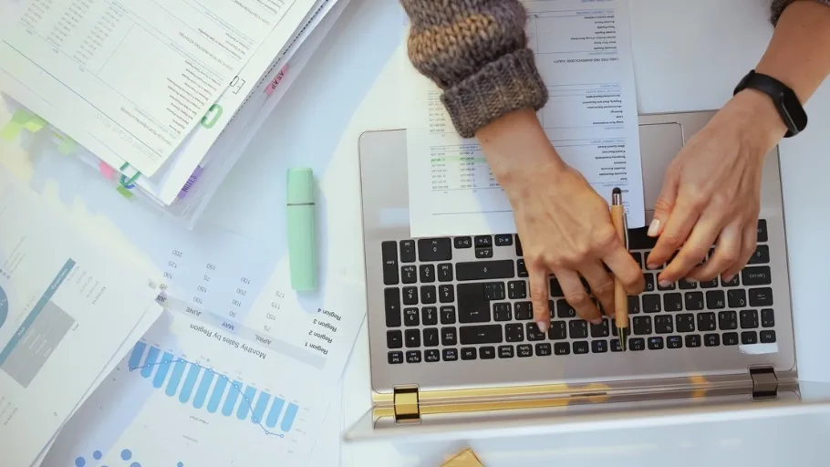 hands of woman on keyboard doing taxes
