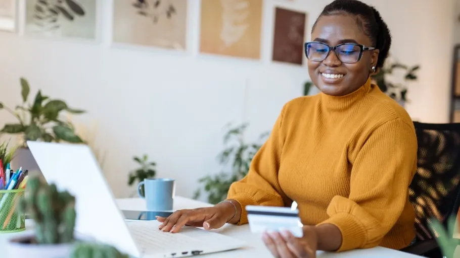 An african american female small business owner using a business credit card