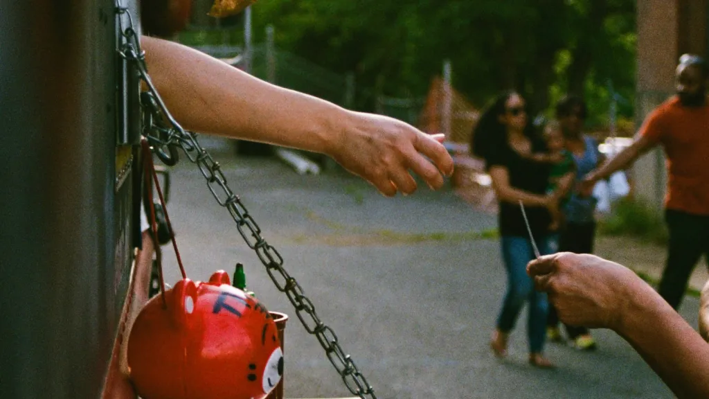 hand reaching out of a vehicle to accept payment