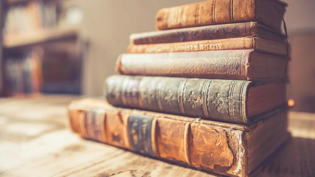 Stack of older books on a wooden table