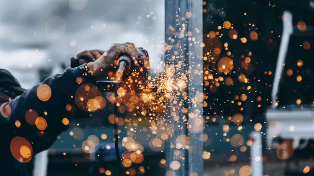 Decorative photo of sparks flying in a workshop to illustrate article about starting a business after bankruptcy.