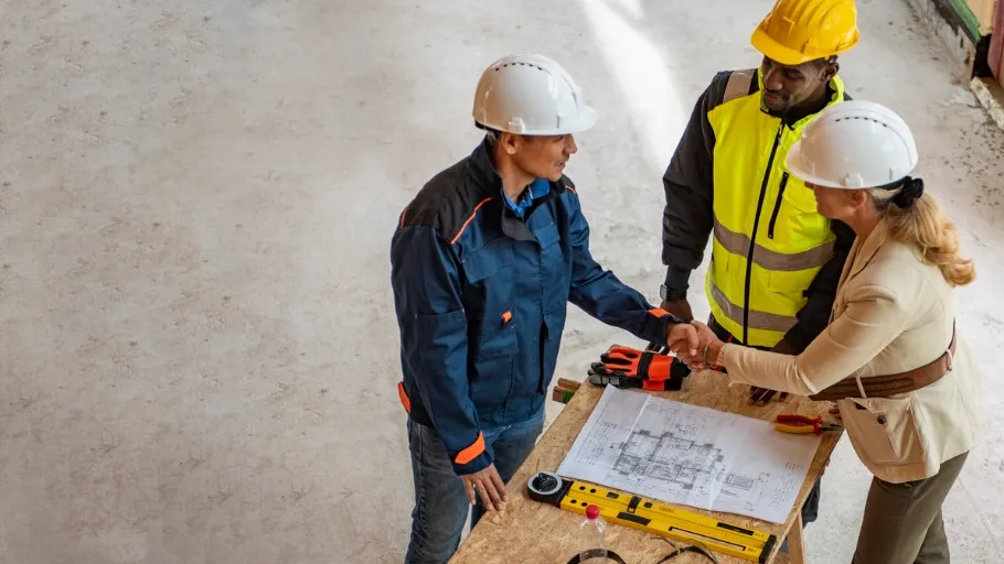 Group of construction workers reviewing plans