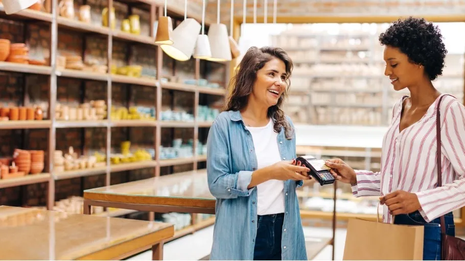 Woman using Arro mastercard to make a purchase at a small business