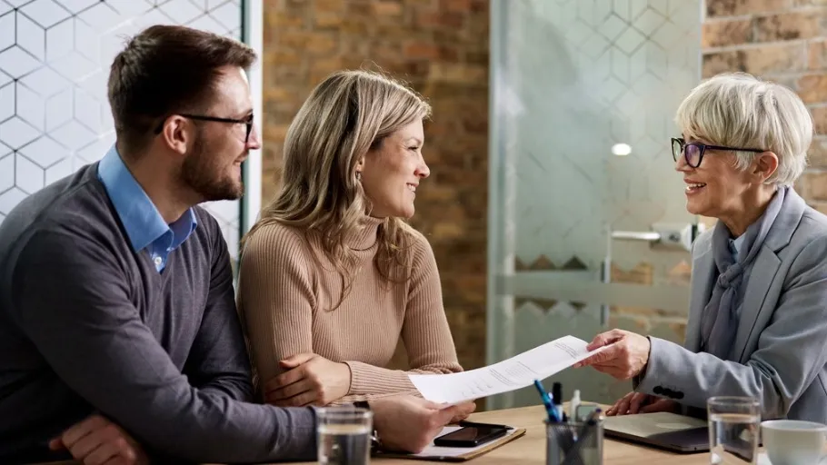 Insurance agent sharing information with male and female clients