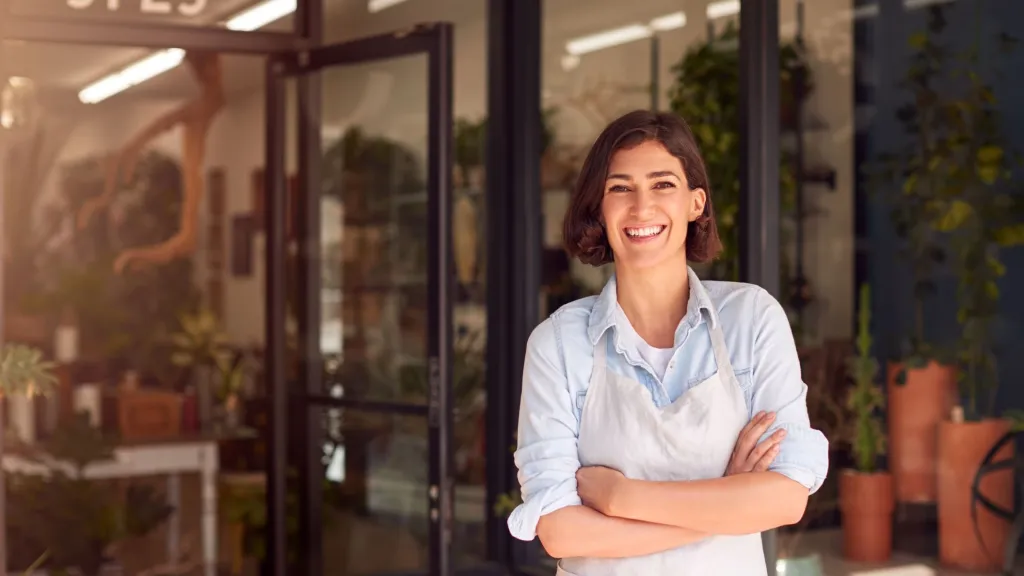 woman in front of store to illustrate article about credit card debt and how it impacts small business owners