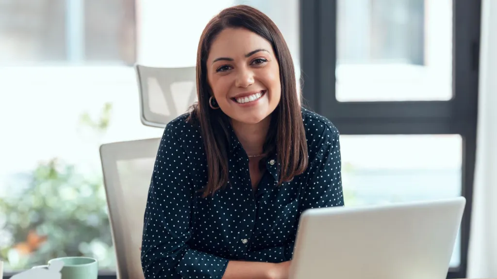 Professional woman smiling to illustrate article about asset protection