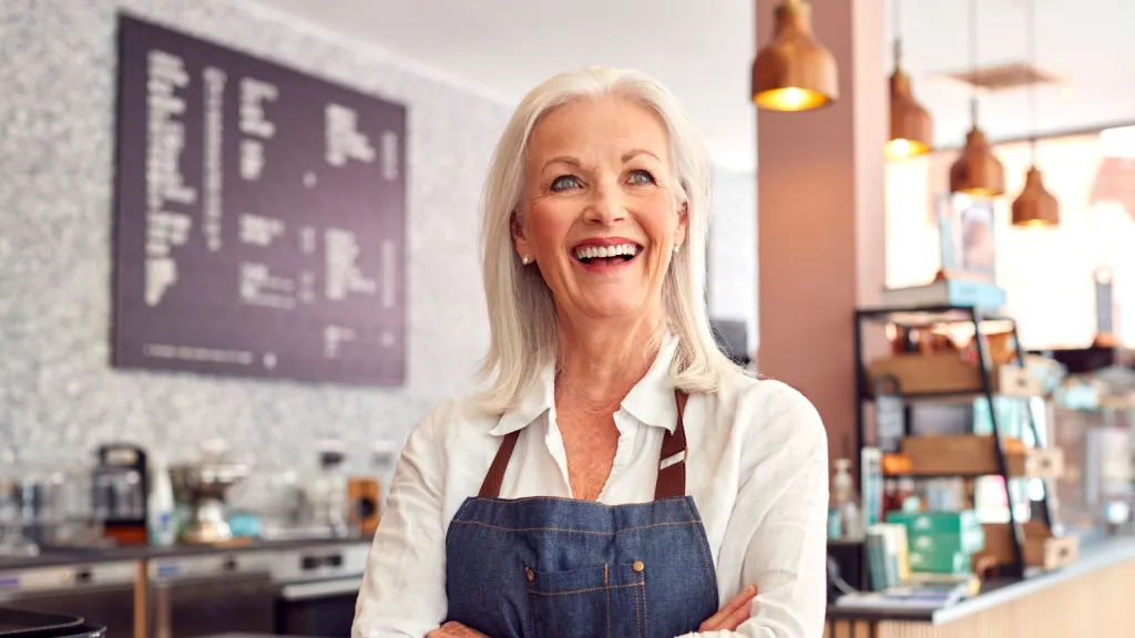 smiling female business owner meant to represent buying a franchise