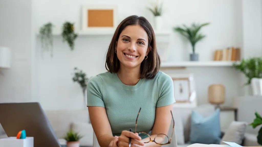 Woman with dark shoulder length hair sitting in office