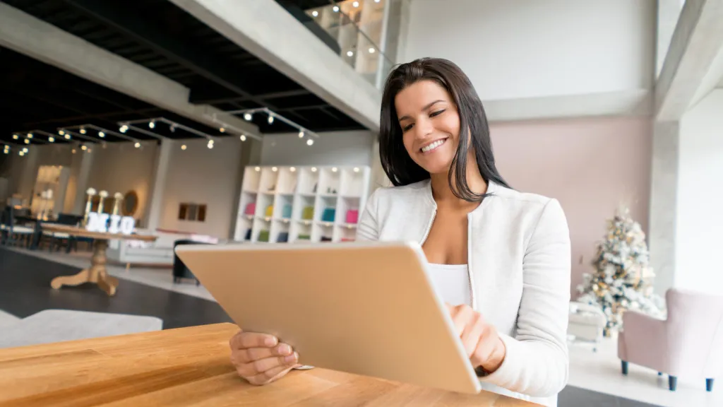 Business owner looking at tablet for commercial loan rates