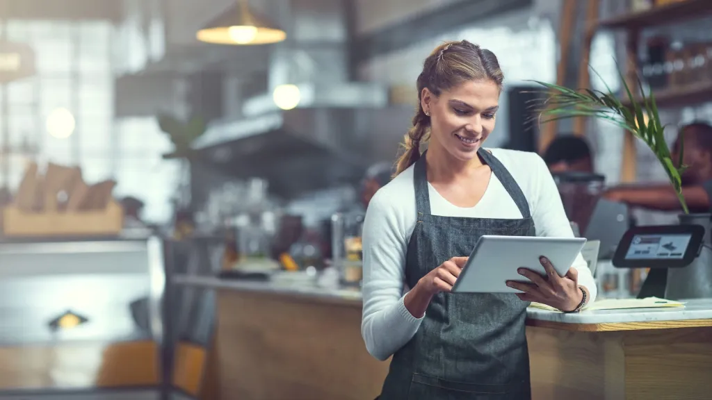 business woman looking at tablet repairing delinquencies on business credit