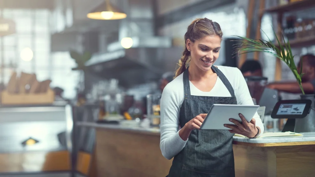 business woman looking at tablet repairing delinquencies on business credit