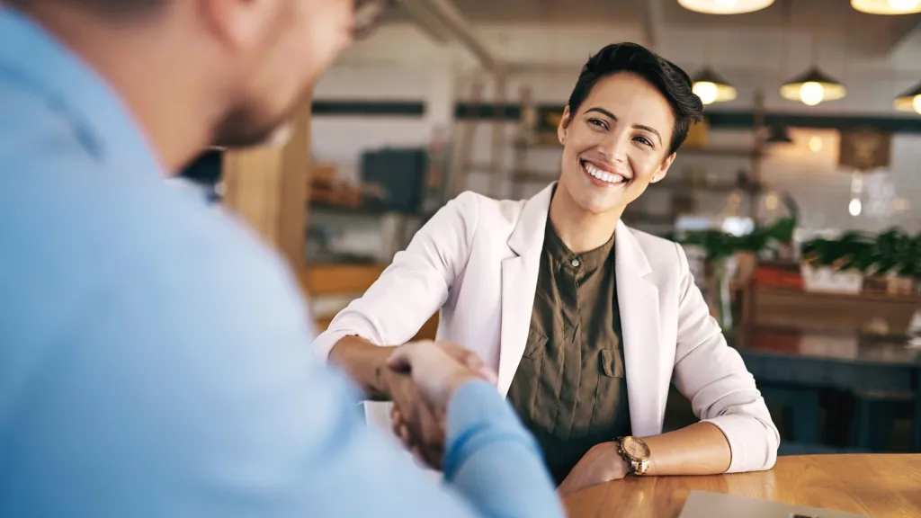 business owner shaking hands acquiring a business