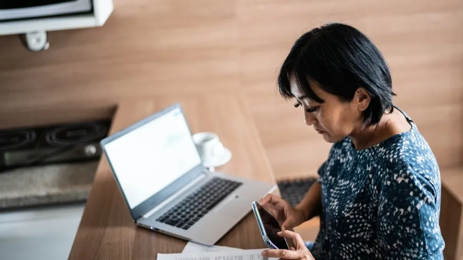 Woman paying bill with online business checking account