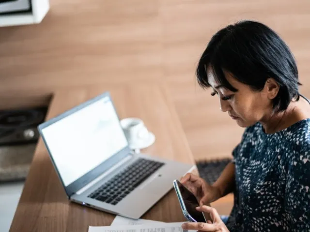 Woman paying bill with online business checking account