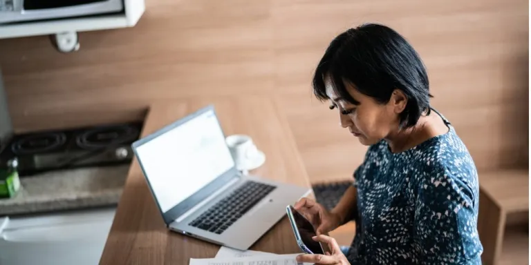 Woman paying bill with online business checking account