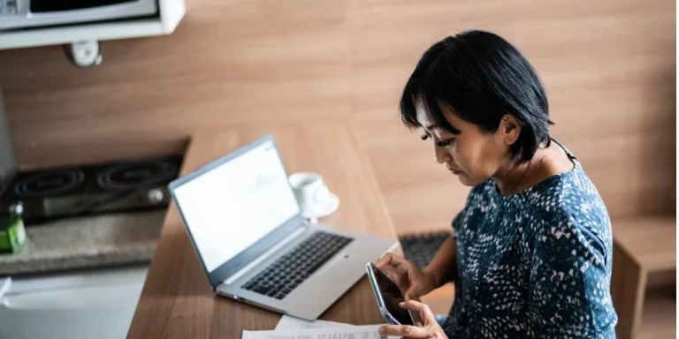 Woman paying bill with online business checking account