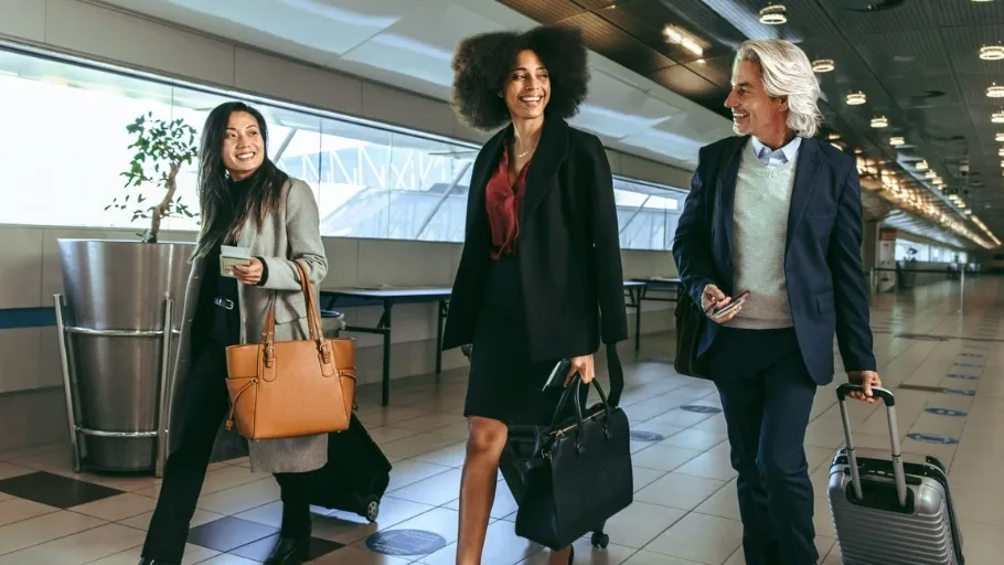 International business travelers using business credit card walking through the airport